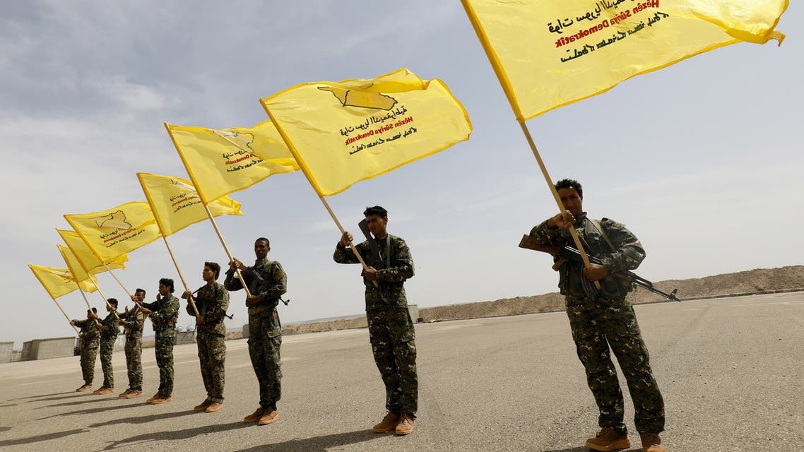 Members of the Syrian Democratic Forces (SDF), trained by the US-led coalition, participate in the graduation ceremony of their first regiment in al-Kasrah, in the suburb of eastern Syrian city of Deir Ezzor, on May 21, 2018.