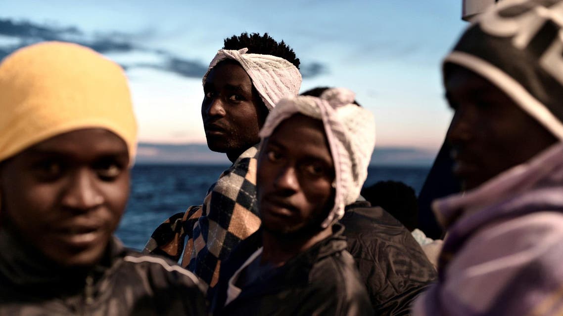 Migrants are seen as they stand on the deck of MV Aquarius on their way to Spain. (Reuters)