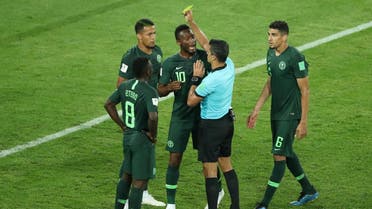 Nigeria's William Troost-Ekong is shown a yellow card by referee Sandro. (Reuters)