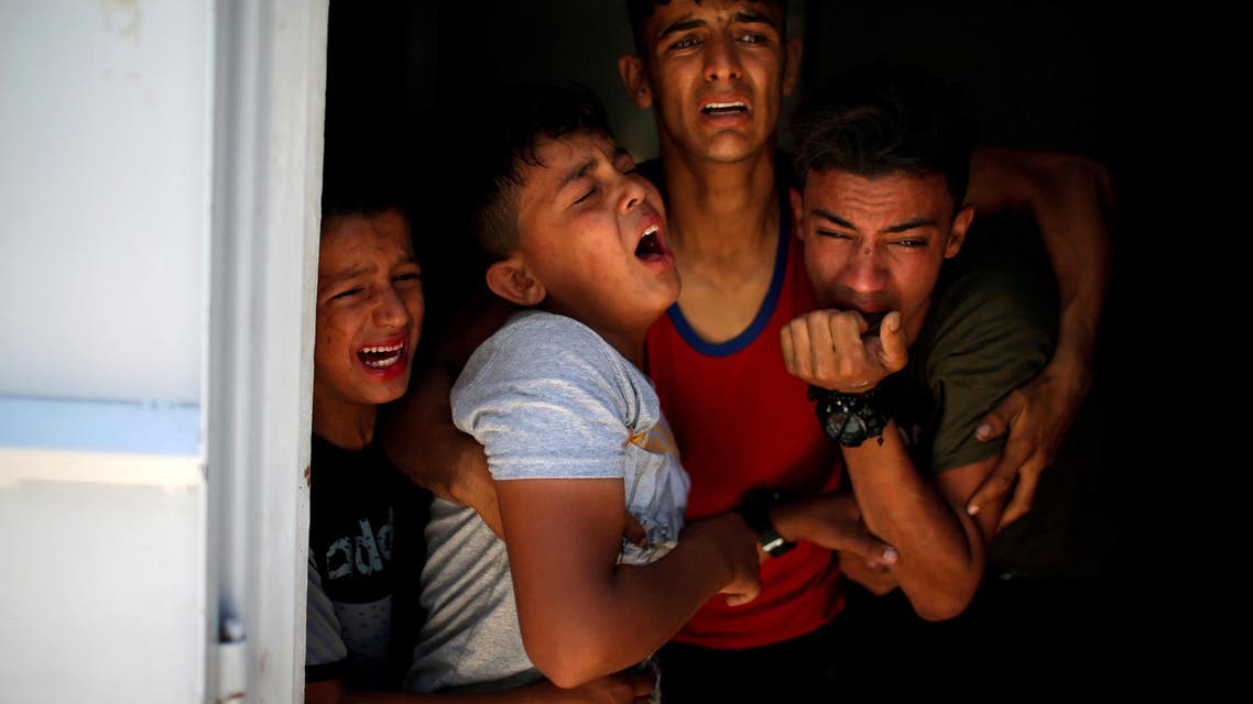 Relatives of a Palestinian, who was killed at the Israel-Gaza border, react at a hospital in Gaza City June 18, 2018. REUTERS