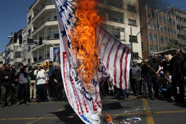 Iranian protesters burn a representation of the US flag at a rally in Tehran on June 8, 2018. (AP)