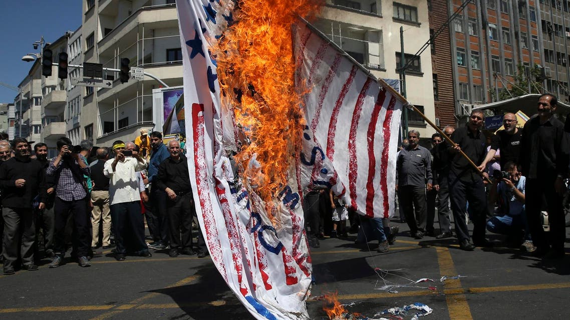 Iranian protesters burn a representation of the US flag at a rally in Tehran on June 8, 2018. (AP)
