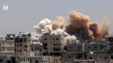 This frame grab from video provided on Monday, June 12, 2017, by Nabaa Media, a Syrian opposition media outlet that is consistent with independent AP reporting, shows smoke rising over buildings that were hit by Syrian government forces bombardment, in Daraa city, southern Syria. (AP)