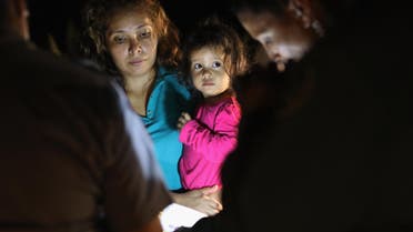 Central American asylum seekers, including a Honduran girl, 2, and her mother, are taken into custody near the U.S.-Mexico border on June 12, 2018 in McAllen, Texas. (AFP)