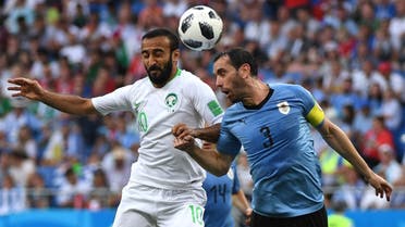 Saudi  forward Mohammed Al-Sahlawi (L) vies with Uruguay’s defender Diego Godin during the Russia 2018 World Cup Group A football match on June 20, 2018.  (AFP)