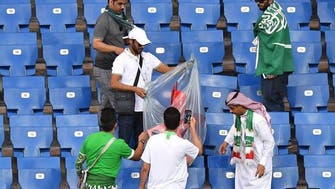Saudi World Cup fans in Russia clean their stadium stands following match
