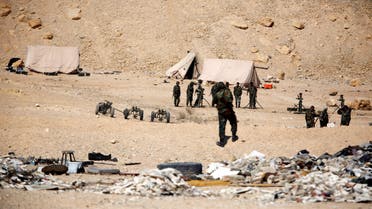 Syrian army soldiers stand near tents and mortar launchers in the historic city of Palmyra, Syria March 4, 2017. REUTERS