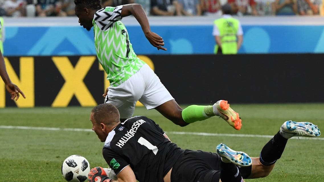 Nigeria’s forward Ahmed Musa (back) avoids Iceland’s goalkeeper Hannes Halldorsson on his way to score their second goal. (AFP)