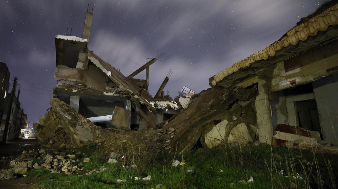 Damaged houses are pictured at night in the rebel-held area, in the city of Daraa, Syria February 18, 2018. (Reuters)