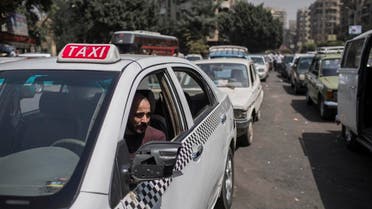 A taxi driver waits in line for fuel at a gas station in Cairo’s neighboring city of Giza, Egypt. (AP)