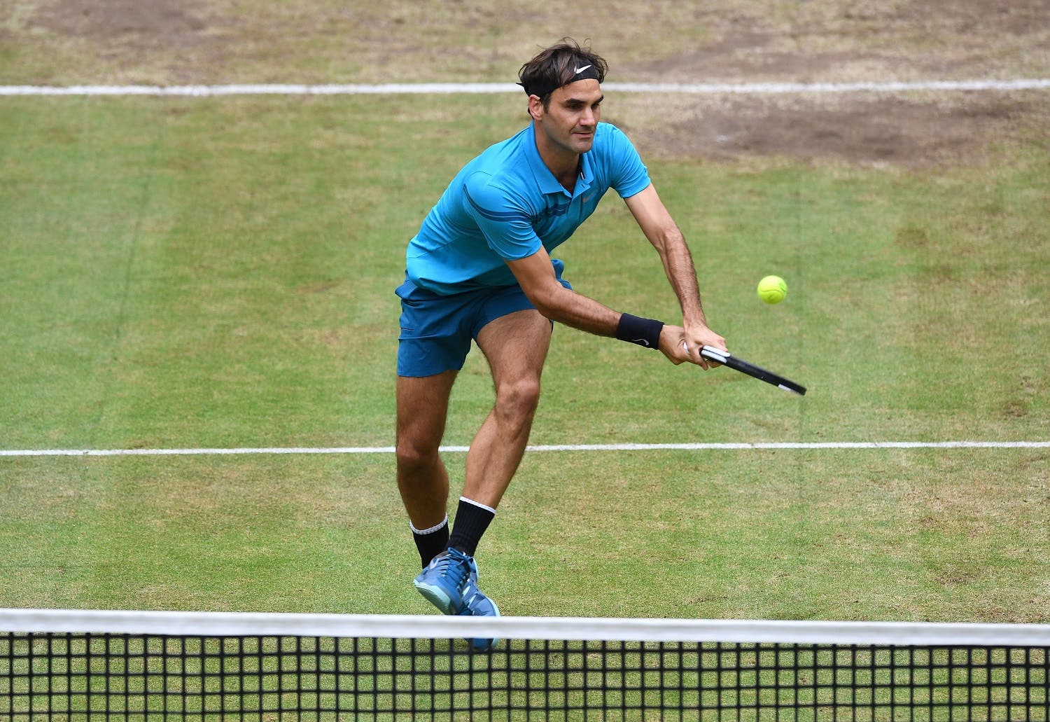 Roger Federer of Switzerland returns a ball to Borna Coric from Croatia during their final match at the ATP tennis tournament in Halle, western Germany, on June 24, 2018. (AFP)