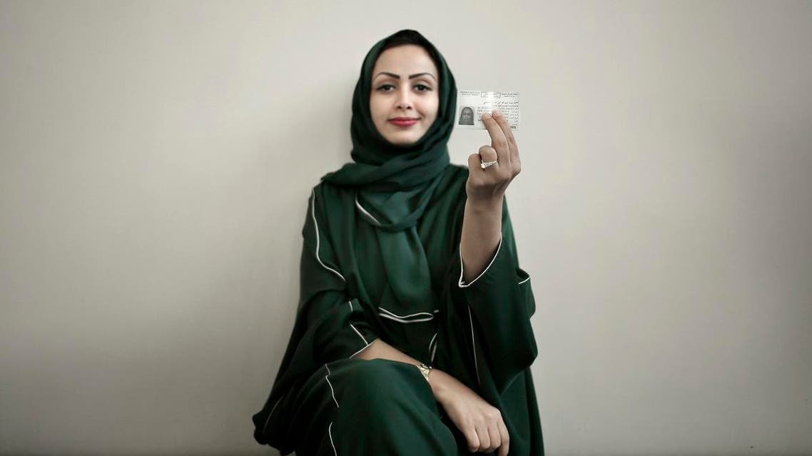 In this June 23, 2018 photo, 34-year old Asmaa al-Assdmi poses for a photograph holding her new car license at the Saudi Driving School inside Princess Nora University in Saudi Arabia. (AP)