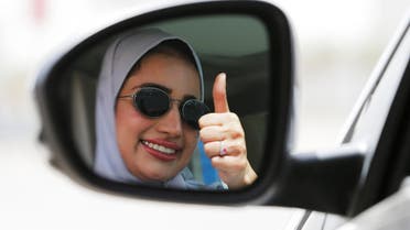 Zuhoor Assiri gestures as she drives her car in Dhahran. (Reuters)