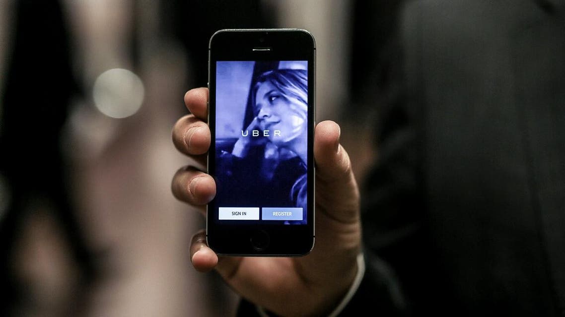 Anthony Khoury, head of Middle East and Africa expansions for Uber, displays the application on a mobile phone during an event to celebrate the official launch of the car-hailing service in Cairo. (Reuters)