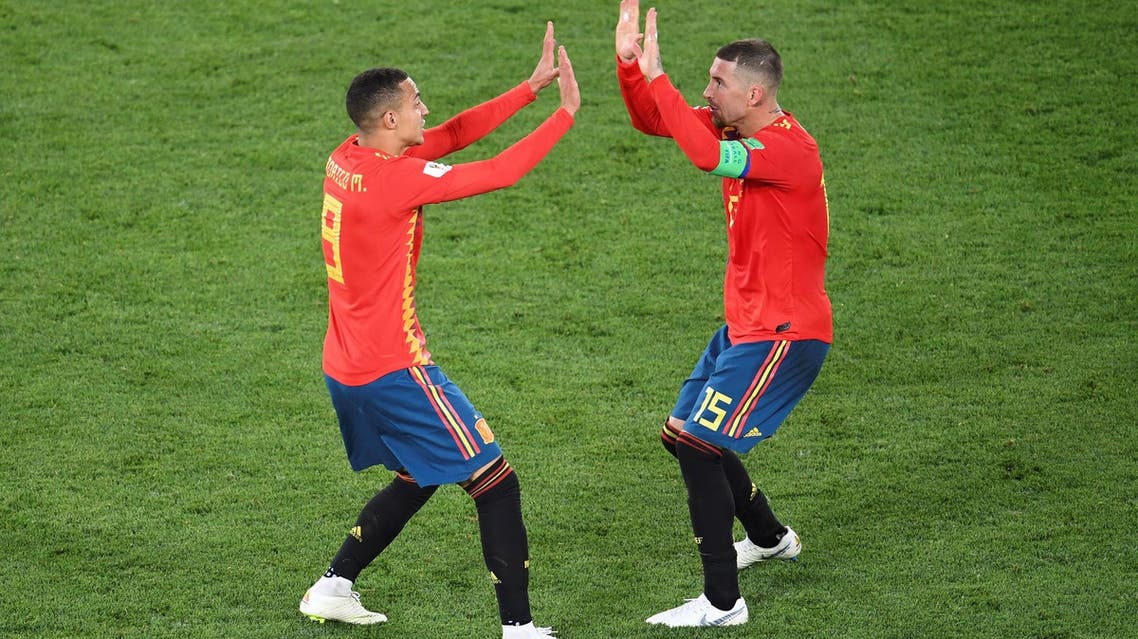 Spain’s Rodrigo (L) and Sergio Ramos celebrate their second goal against Morocco in Kaliningrad on June 25, 2018. (AFP)