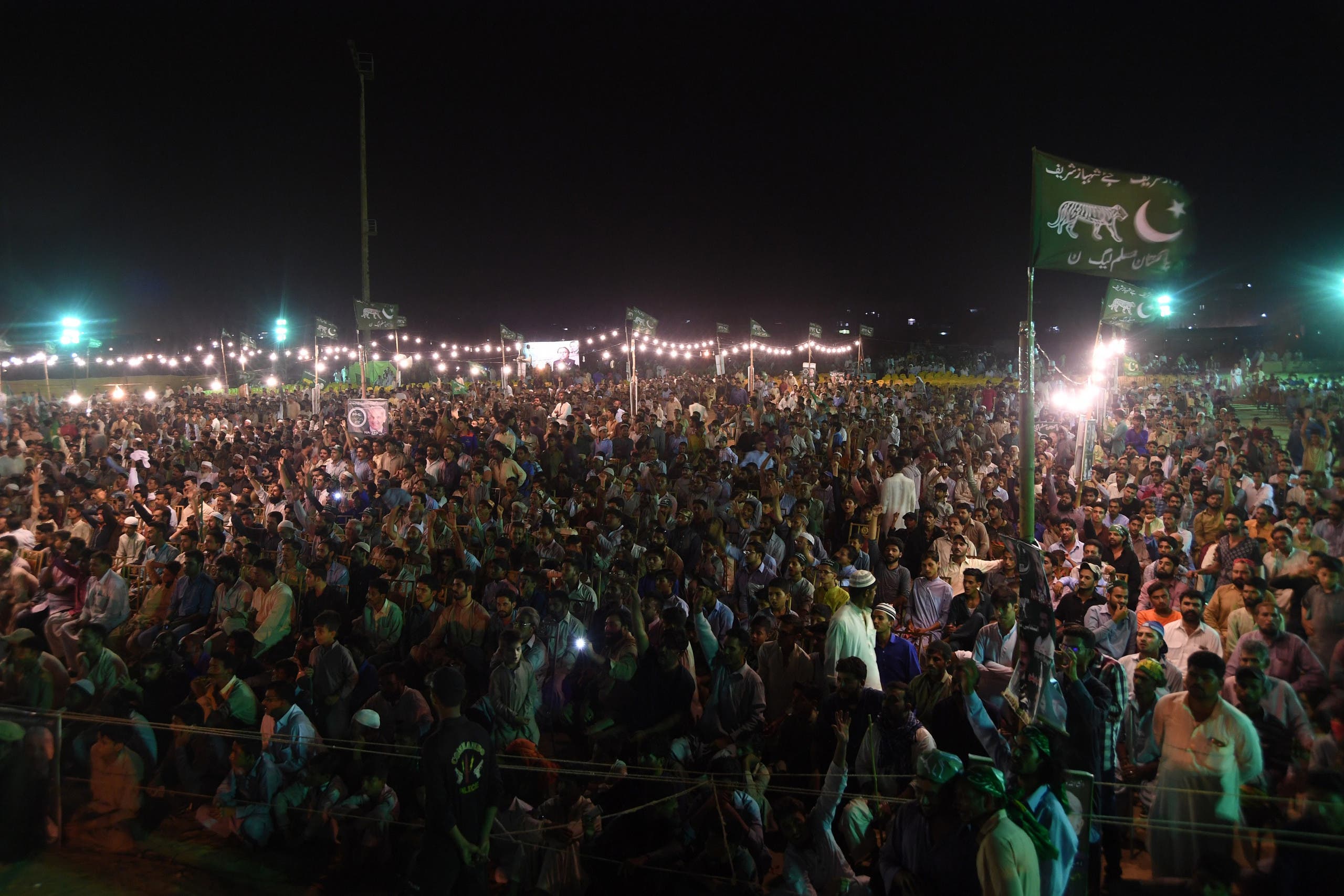 Supporters of Shahbaz Sharif, the younger brother of ousted Pakistani prime minister Nawaz Sharif and the head of Pakistan Muslim League -Nawaz (PML-N), during a campaign meeting in Karachi on June 25, 2018. (AFP)