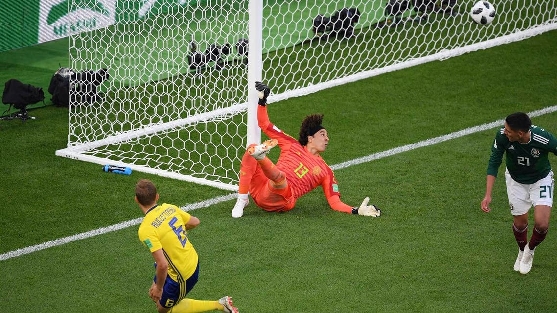 Sweden’s defender Ludwig Augustinsson (L) scores the opening goal past Mexico’s goalkeeper Guillermo Ochoa in the 2018 World Cup Group F football match on June 27, 2018. (AFP)