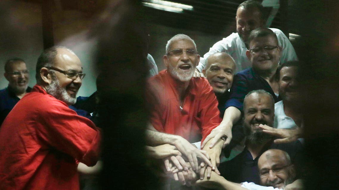 Egyptian defendants including Muslim Brotherhood spiritual leader, Mohammed Badie, center in orange, react to a court ruling in Cairo on June 16, 2015. (AP)