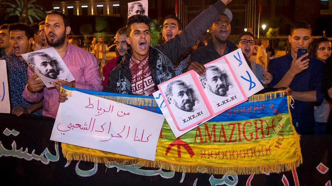 Protesters hold portraits of grassroots leader Nasser Zefzafi during a demonstration June 4, 2017 in Rabat in solidarity with Morocco's neglected Rif region. (AFP)