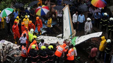 Firefighters and aircraft rescue workers inspect the site of a plane crash in Mumbai on June 28, 2018. (Reuters)