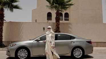 Ammal Farahat, who has signed up to be a driver for Careem, a regional ride-hailing service that is a competitor to Uber, poses for a photograph next to her car on a street in Riyadh, Saudi Arabia. (AP)