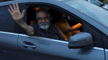 Journalist Mehmet Altan waves to media after being released from the prison in Silivri, near Istanbul, Turkey, June 27, 2018. REUTERS