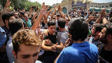A group of protesters chant slogans at the main gate of old grand bazaar in Tehran on June 25, 2018. (Iranian Labor News Agency via AP)