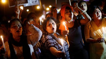 Women hold candles as they shout slogans during a protest against the rape of a 10-year-old girl, in the outskirts of Delhi on April 25, 2018. (Reuters)
