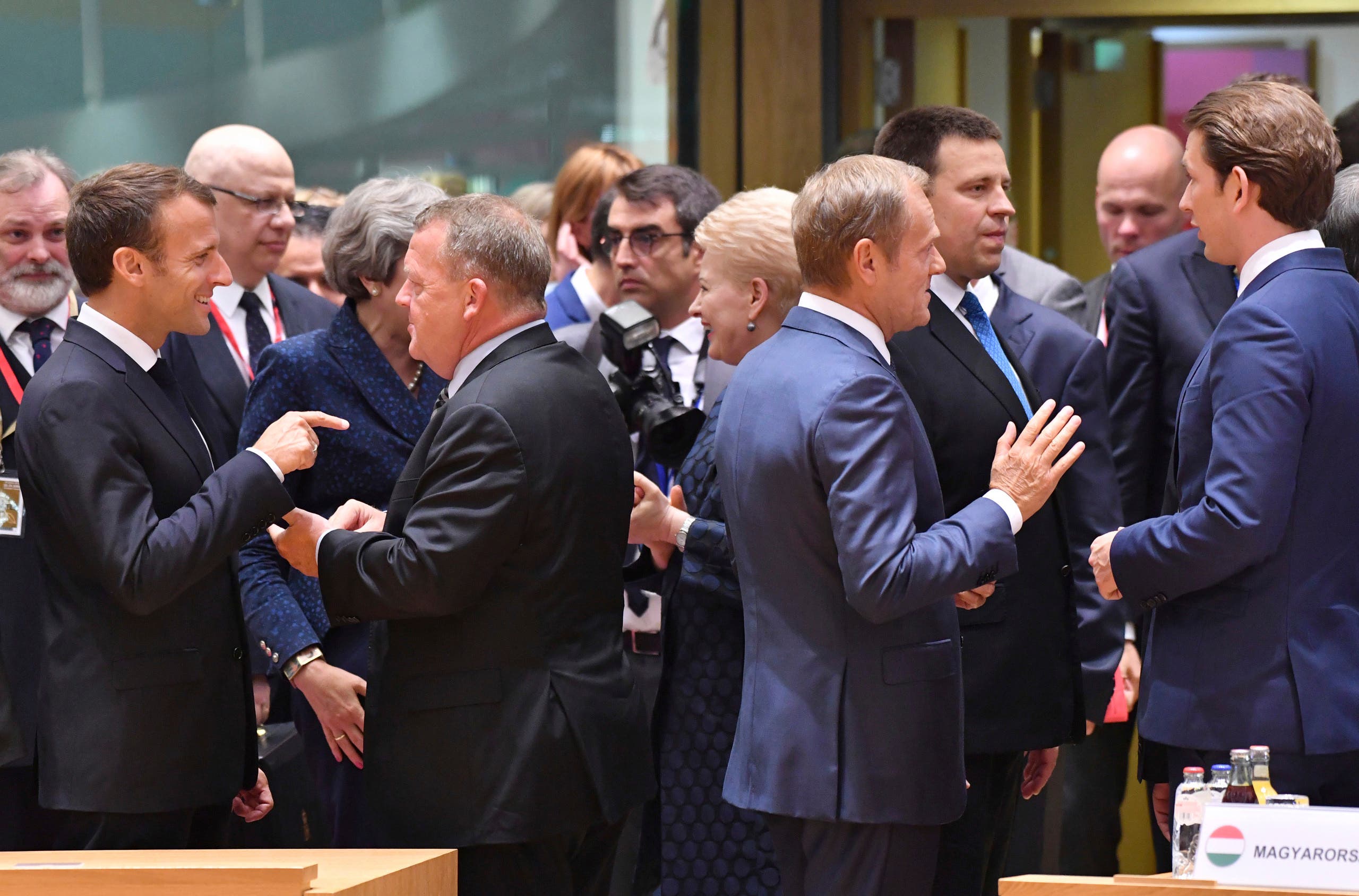 French President Emmanuel Macron, left, speaks with Danish Prime Minister Lars Lokke Rasmussen as Austrian Chancellor Sebastian Kurz, right, speaks with European Council President Donald Tusk during a round table meeting at an EU summit in Brussels, Thursday, June 28, 2018. AP)