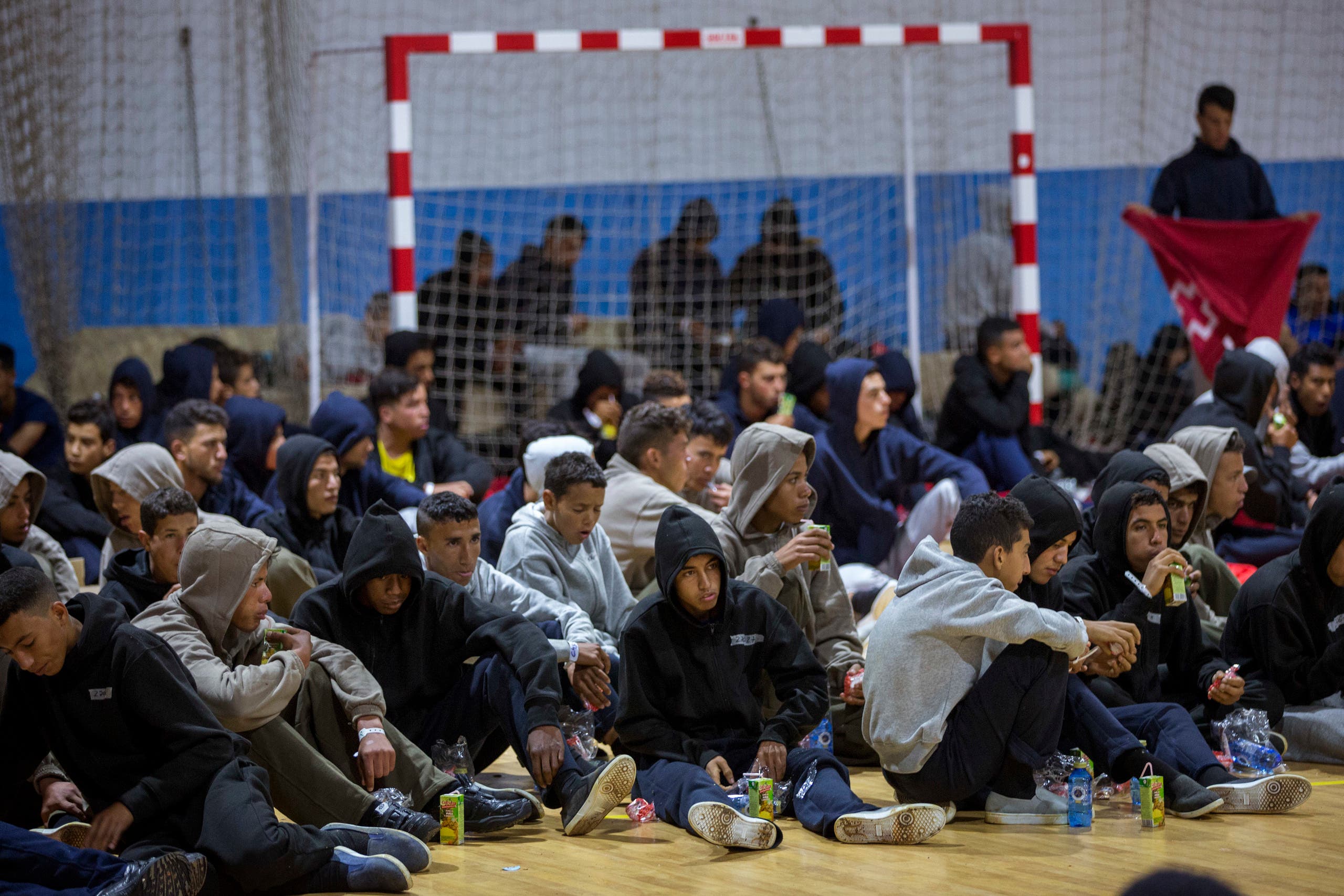 Moroccan migrants rest at a makeshift emergency center at Barbate's municipal sports center, in the south of Spain, after being rescued by Spain's Maritime Rescue Service in the Strait of Gibraltar, Thursday, June 28, 2018. (AP)