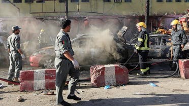 Afghan policemen inspect the site of a blast in Jalalabad city, Afghanistan, on July 1, 2018. (Reuters)