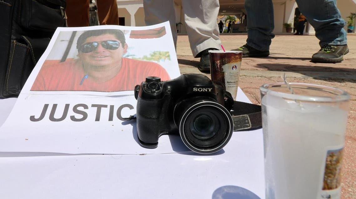 The portrait of Mexican journalist Jose Guadalupe Chan is seen as his colleagues protest outside the City Hall in Playa del Carmen, Quintana Roo state, Mexico. (Reuters)