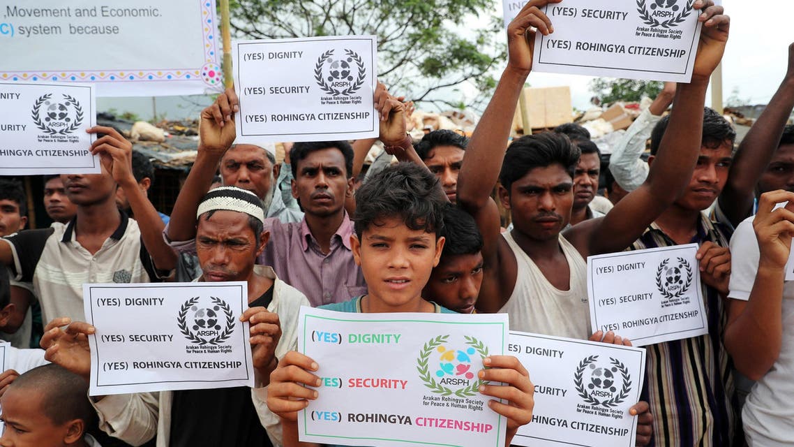 Rohingya refugees hold placards prior to the arrival of UN secretary general Antonio Guterres and World Bank president Jim Yong Kim at the Kutupalong refugee camp in Cox’s Bazar, Bangladesh, July 2, 2018. REUTERS