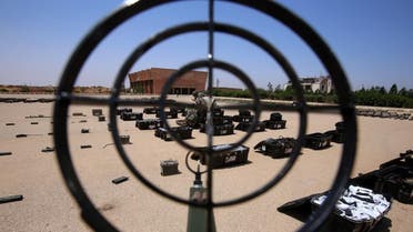Syrian government forces' soldiers display weapons confiscated from the rebels in a Syrian army military base in the town of Ezraa, province of Daraa, on July 4. (AFP)