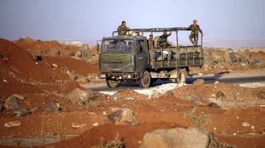 Syrian government soldiers ride in an army truck near the Nassib border crossing with Jordan in the southern province of Daraa on July 6, 2018, after they regained control over it from rebel forces. The Nassib crossing was overrun by rebels in April 2015, sealing off the regime's crucial trade route with neighbouring Jordan, which calls it Jaber. With the crossing's recapture two weeks into a Russian-backed offensive, the government hopes it can reopen the vital trade lifeline.