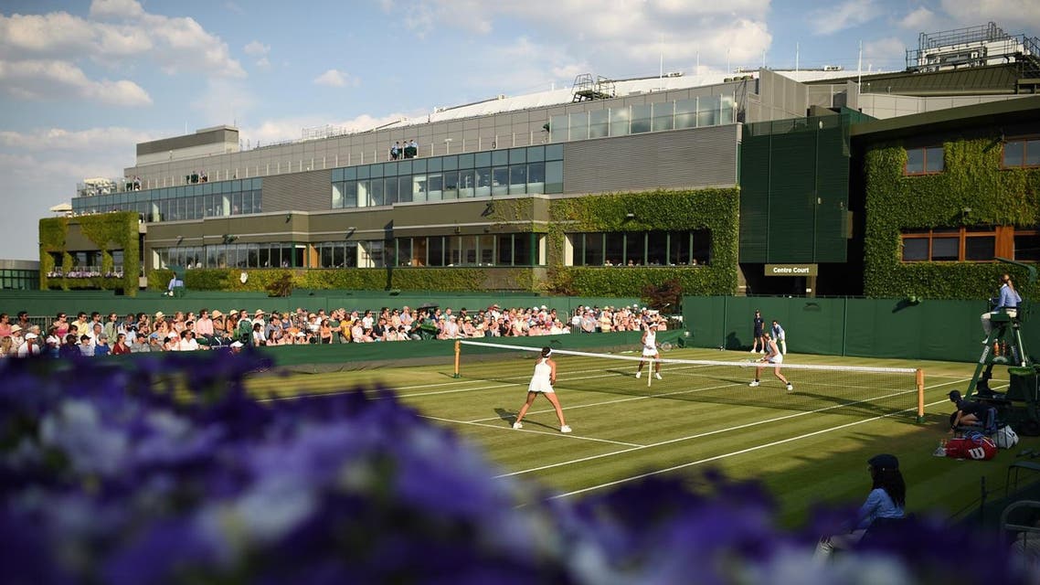 Spectators watch a game of doubles on the fifth day of the 2018 Wimbledon Championships at The All England Lawn Tennis Club in Wimbledon, southwest London, on July 6, 2018. (AFP)