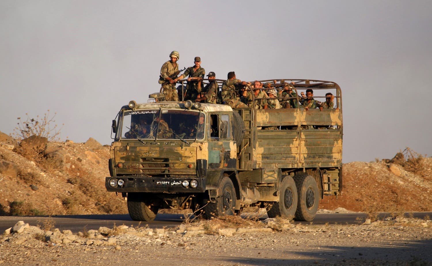 Syrian soldiers ride in an army truck near the Naseeb border crossing with Jordan in the southern province of Daraa on July 6, 2018, after they regained control over it from rebel forces. (AFP)
