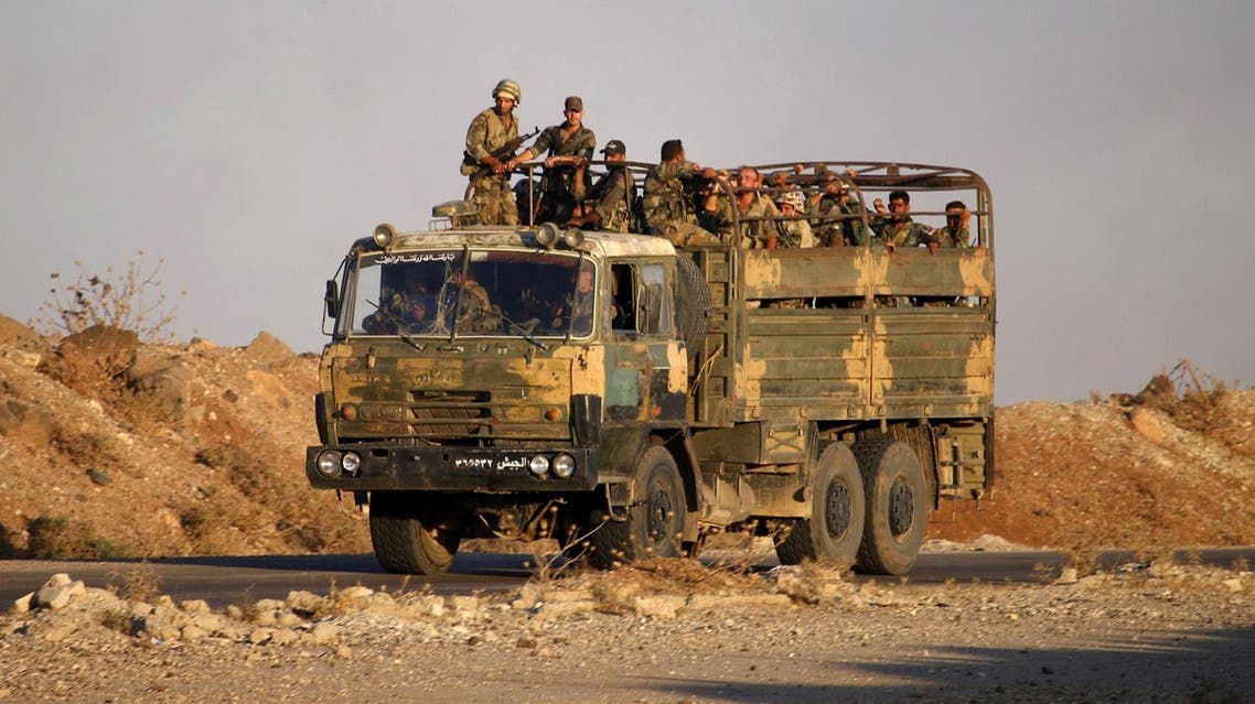 Syrian soldiers ride in an army truck near the Naseeb border crossing with Jordan in the southern province of Daraa on July 6, 2018, after they regained control over it from rebel forces. (AFP)