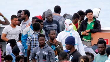 Migrants wait to disembark the Italian coast guard vessel ‘Diciotti’ in the port of Catania, Italy. (Reuters)