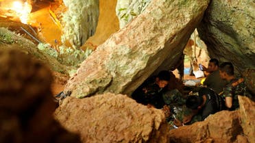 Rescue workers rest inside Tham Luang cave complex, where 12 schoolboys and their soccer coach are trapped inside a flooded cave, in the northern province of Chiang Rai, Thailand, on July 7, 2018. (Reuters)