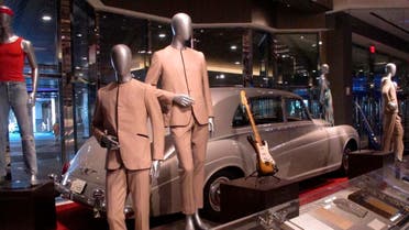 Suits worn by the Beatles during an early tour of America in front of the Rolls Royce automobile owned by Elvis Presley, part of a large collection of music memorabilia on display at the Hard Rock casino in Atlantic City, N.J. (AP)