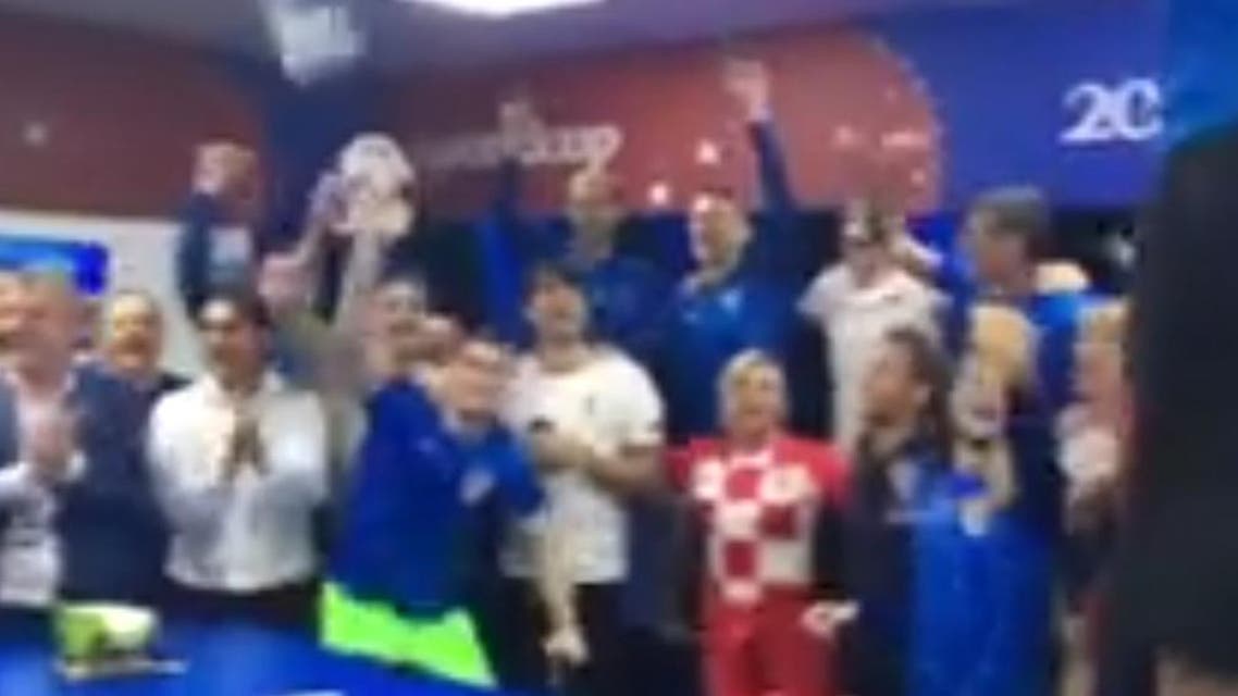 Kolinda Grabar-Kitarovic is seen dancing and singing along with the members of the Croatian team in the dressing room. (Screenshot)