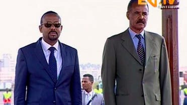 In this grab taken from video provided by ERITV, Ethiopia's Prime Minister Abiy Ahmed, left and Erirea's President Isaias Afwerki observe the Guard or Honour during a welcome ceremony for Ahmed, in Asmara, Eritrea. (AP)