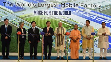 Moon Jae-in and Modi cut ribbons during the inauguration of the world's largest mobile factory at the Samsung India electronics private limited in Noida. (AFP)