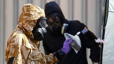 Forensic investigators, wearing protective suits, emerge from the rear of John Baker House, after it was confirmed that two people had been poisoned with the nerve-agent Novichok, in Amesbury. (Reuters)