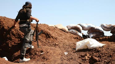 A Syrian rebel carries his machinegun during battles with pro-government fighters in western Daraa province on July 10, 2018. (AFP)