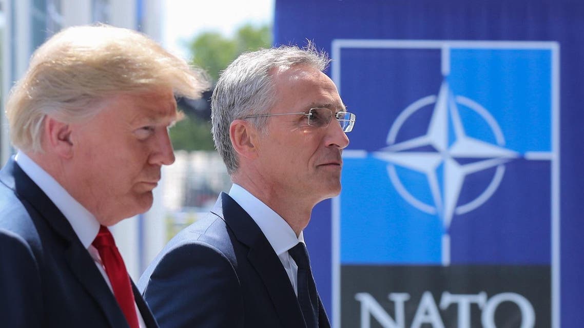 US President Donald Trump (L) walks with NATO Secretary General Jens Stoltenberg as he arrives to attend the NATO summit, in Brussels, on July 11, 2018. (AFP)