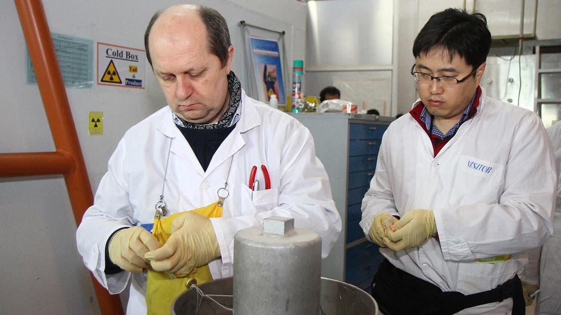 Unidentified IAEA inspectors seal after disconnecting the connections between the twin cascades for 20 percent uranium production at nuclear power plant of Natanz on January, 20, 2014. (AFP)