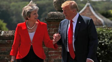 Britain’s Prime Minister Theresa May and US President Donald Trump walk to a joint news conference at Chequers, the official country residence of the Prime Minister, near Aylesbury, Britain, on July 13, 2018. (Reuters)