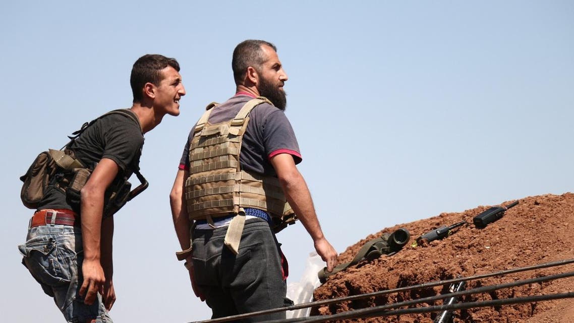 Syrian rebels watch for pro-government fighters in western Daraa province on July 10, 2018. (AFP)